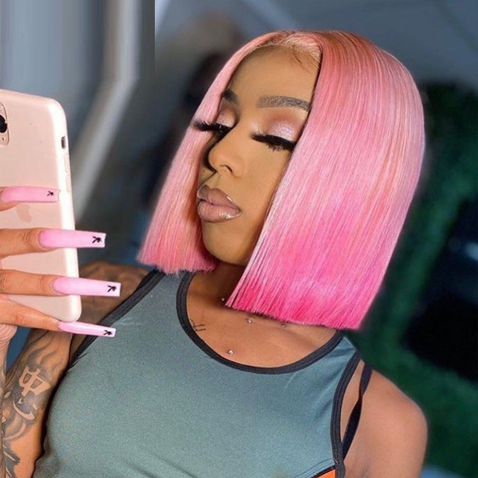 Woman with pink hair taking a selfie with a phone.