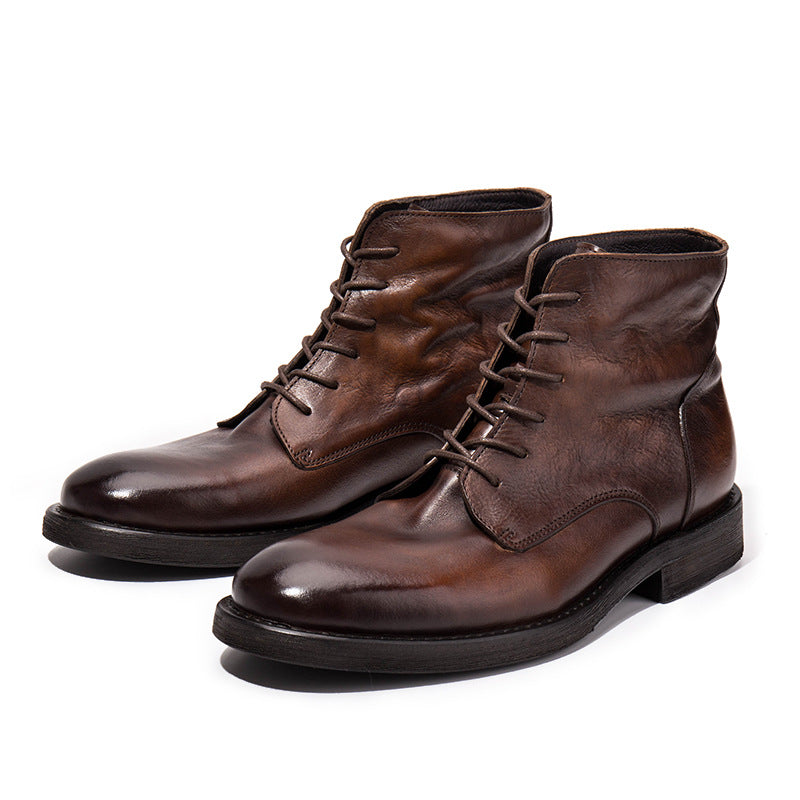 Pair of brown leather boots on a white background