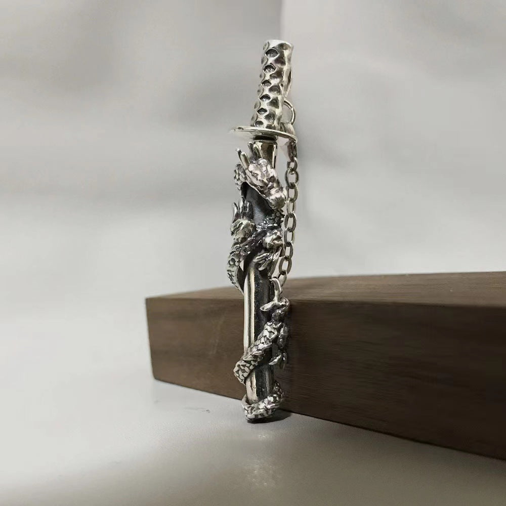 Decorative silver object on a wooden block with a neutral background