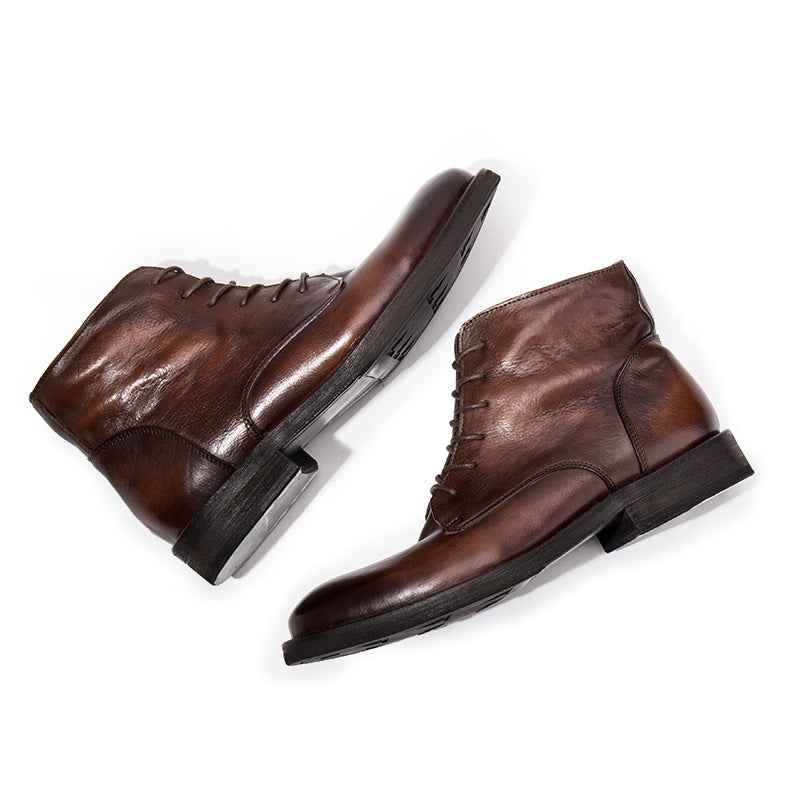 Pair of brown leather boots on a white background