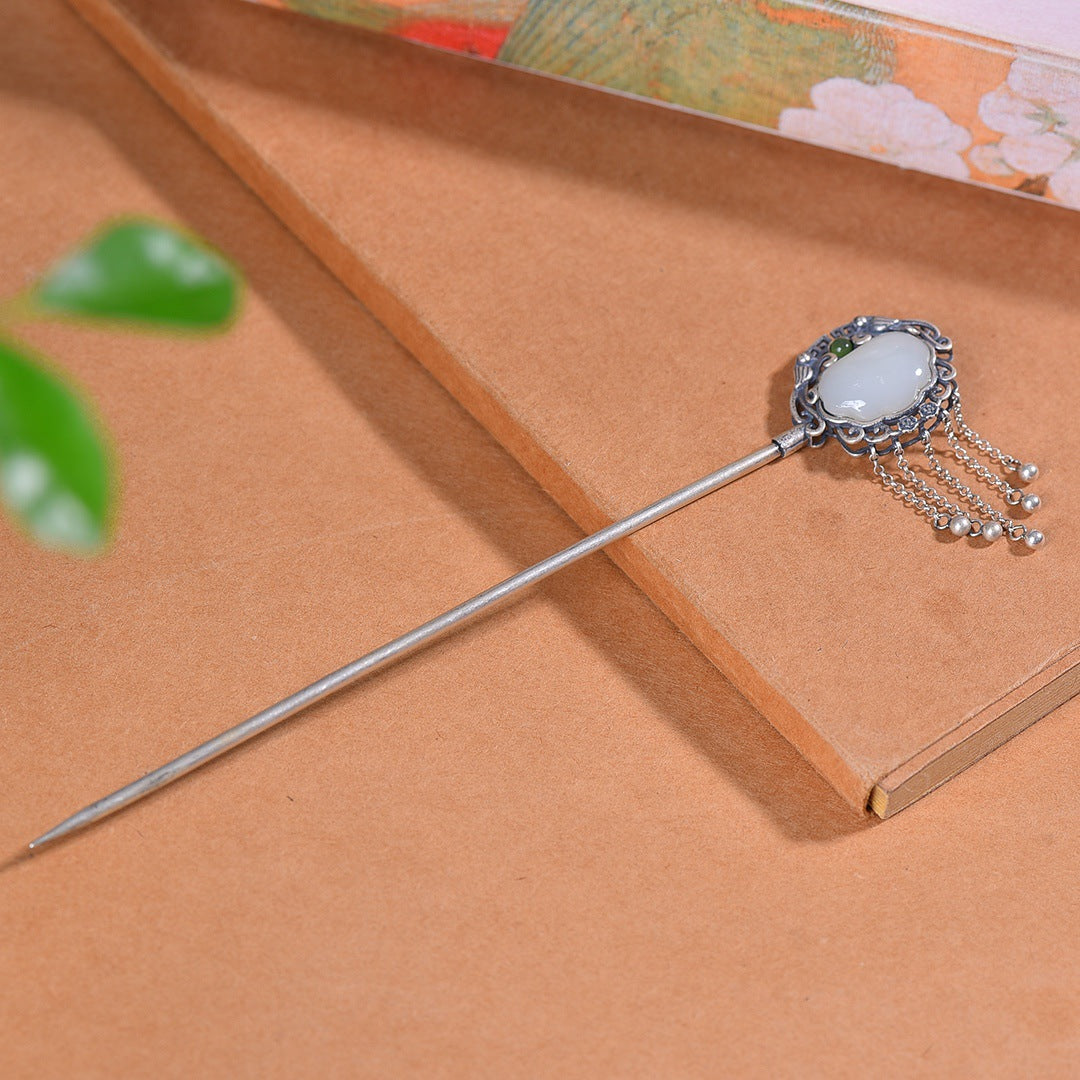 Decorative hairpin with gemstone on a brown surface