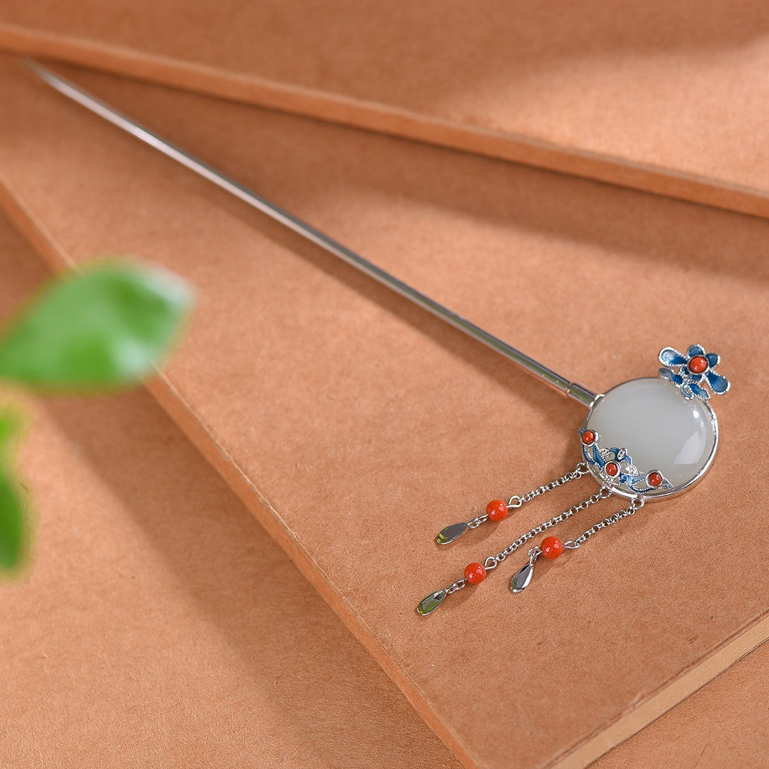 Decorative hairpin with floral design on a brown surface