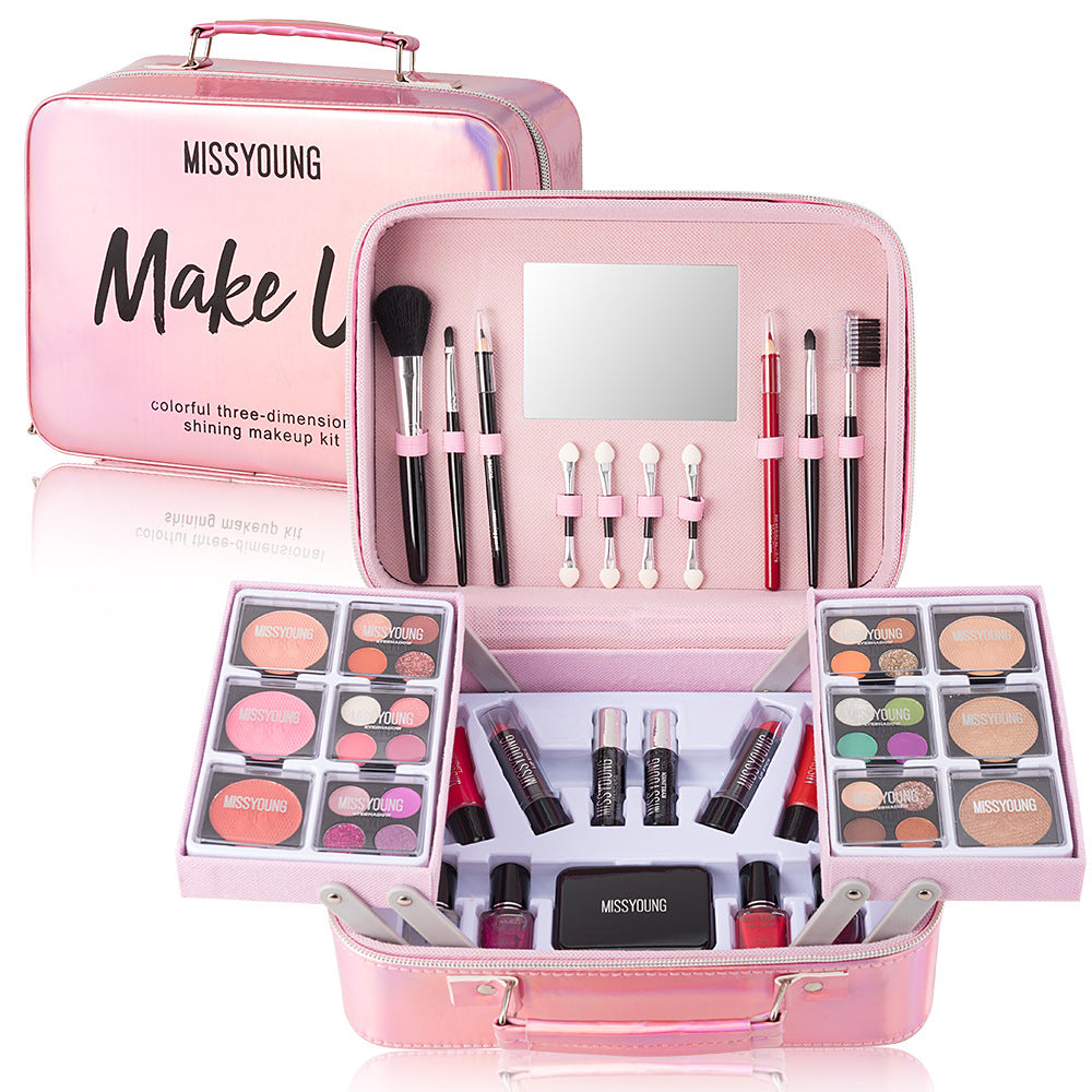 Pink makeup kit with various cosmetic items and tools on a white background