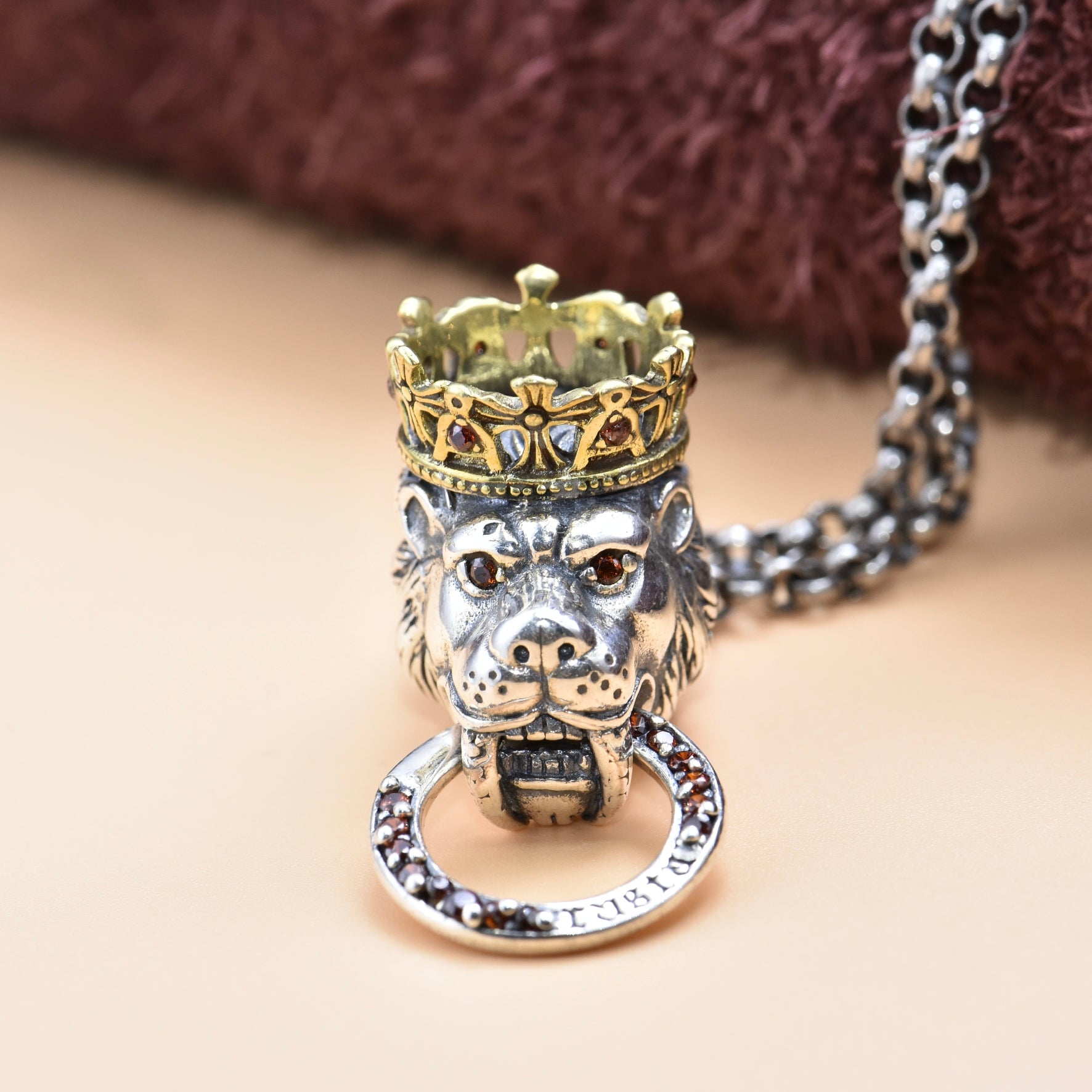 Lion head necklace with a crown on a neutral background
