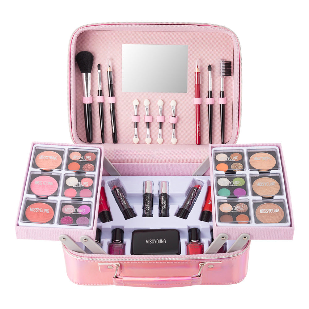 Pink makeup set with various cosmetic items and tools on a white background