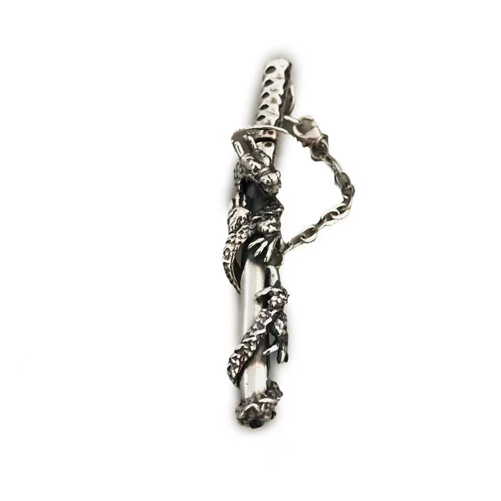 Silver pendant with intricate design on a white background