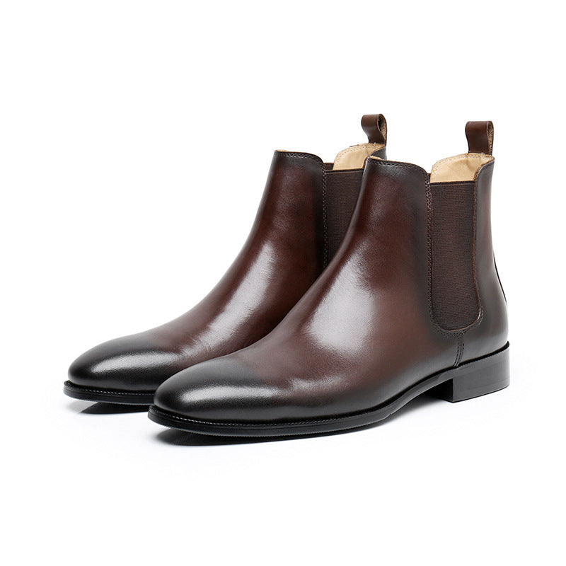 Pair of brown leather Chelsea boots on a white background