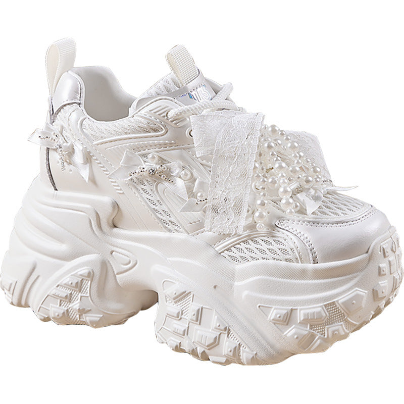 White lace-up sneaker with decorative elements on a white background