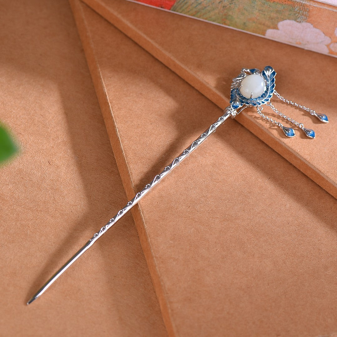 Decorative hairpin with gemstone on a brown surface