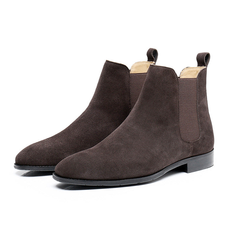 Pair of brown suede Chelsea boots on a white background
