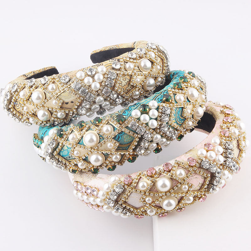 Decorative headband with pearls and gemstones on a white background