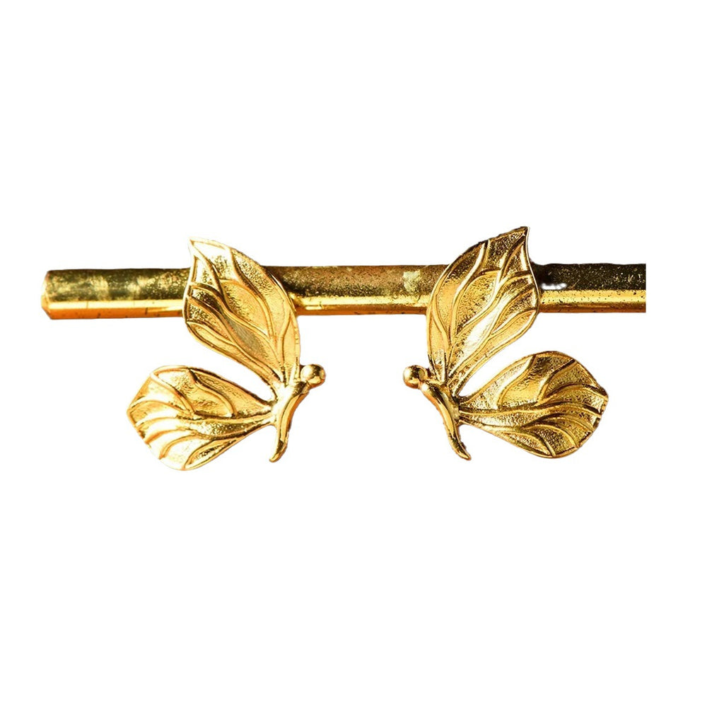 Gold hair barrette with leaf designs on a white background