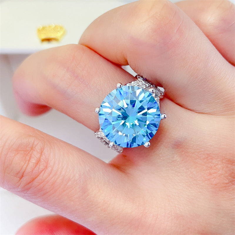 10 Karat Blue Moissanite Luxury Full Diamond Female Ring with large blue gemstone on hand close-up view.