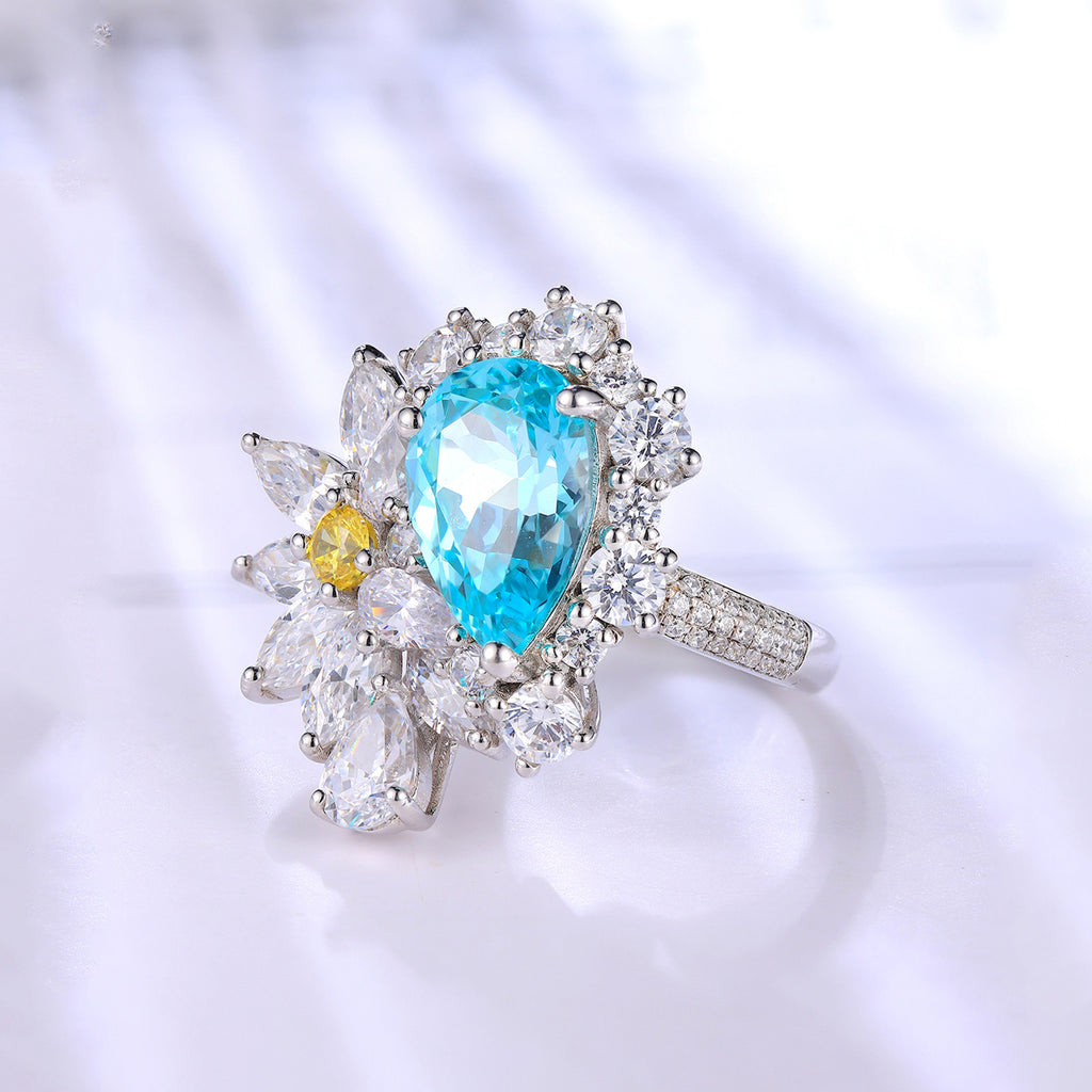 Jewelry with a blue gemstone and white stones on a blurred background