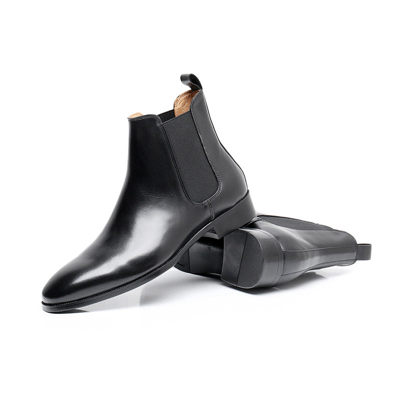 Black leather Chelsea boots on a white background