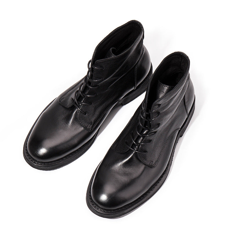 Pair of black leather boots on a white background