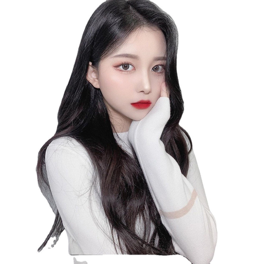Woman with long dark hair wearing a white outfit on a white background