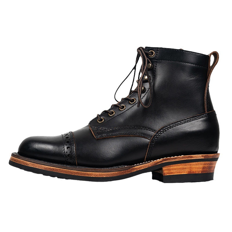Black leather boot with brown sole on a white background