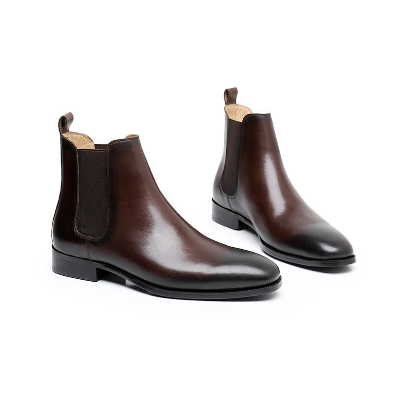 Pair of brown leather Chelsea boots on a white background