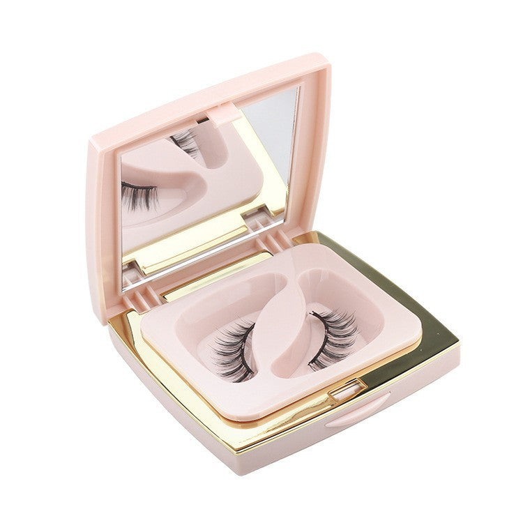 Set of false eyelashes in a compact case with a mirror on a white background