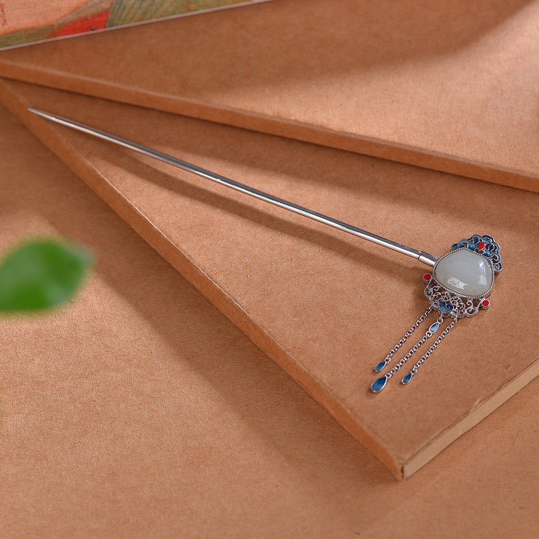 Decorative hairpin with gemstone on a brown fabric background