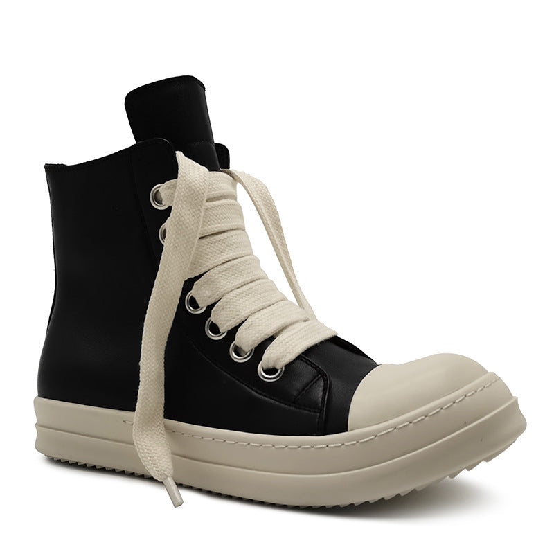 Black and beige high-top sneaker with white laces on a white background