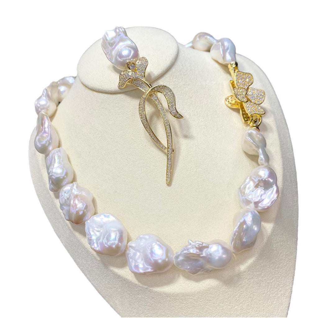 Pearl necklace with gold butterfly pendants on a heart-shaped stand