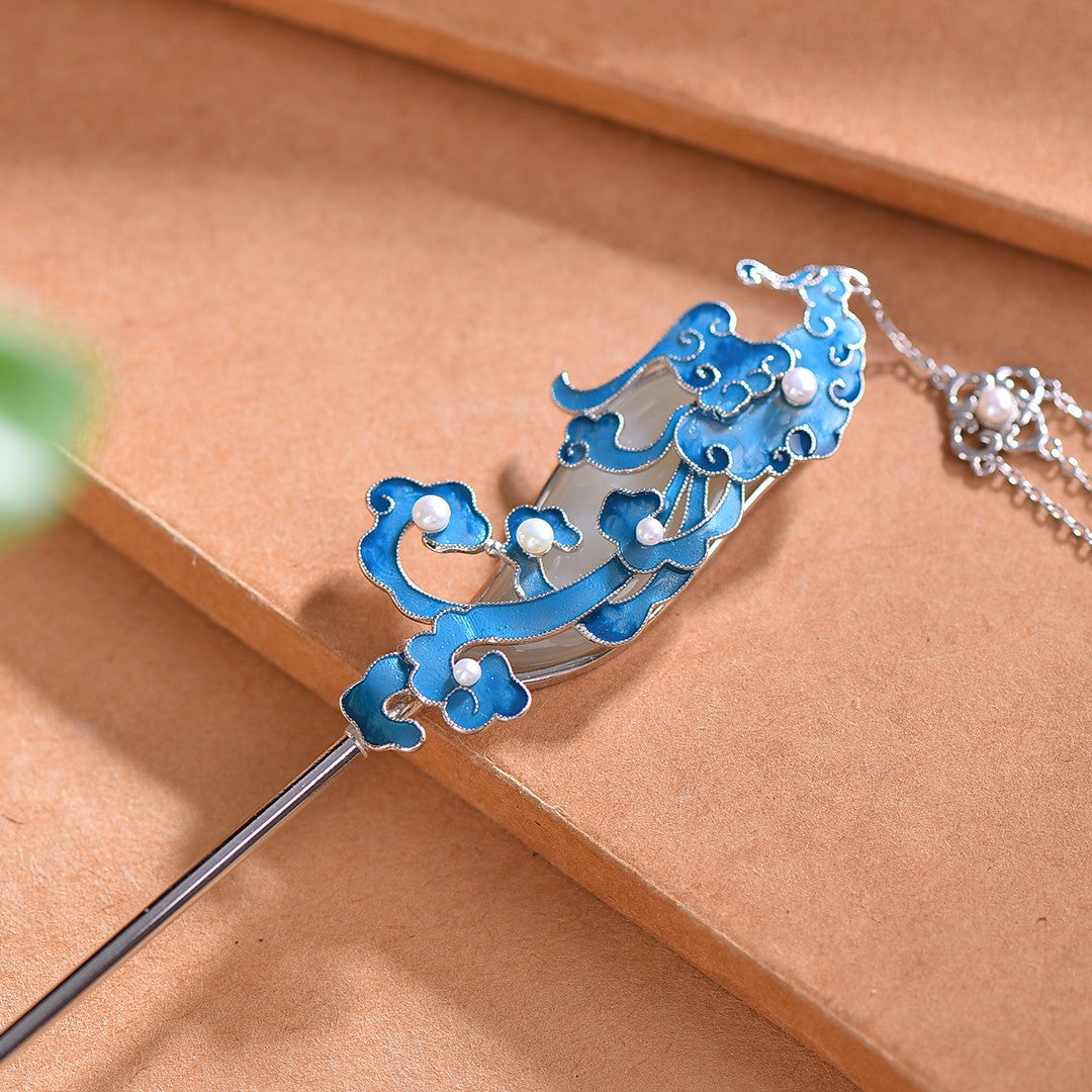Decorative hairpin with blue and silver design on a brown surface
