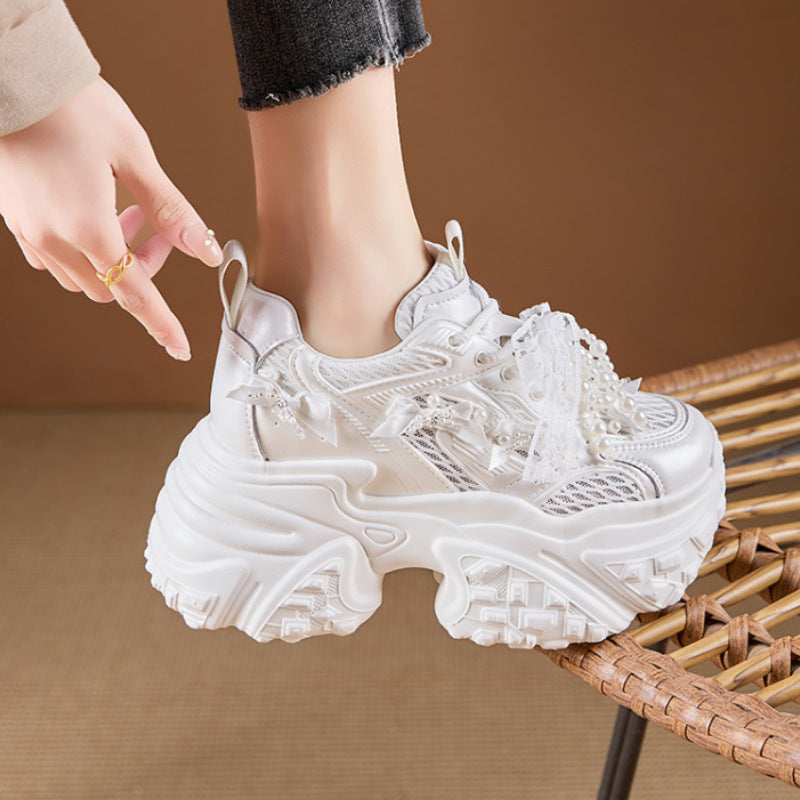 White sneaker with textured sole on a brown background