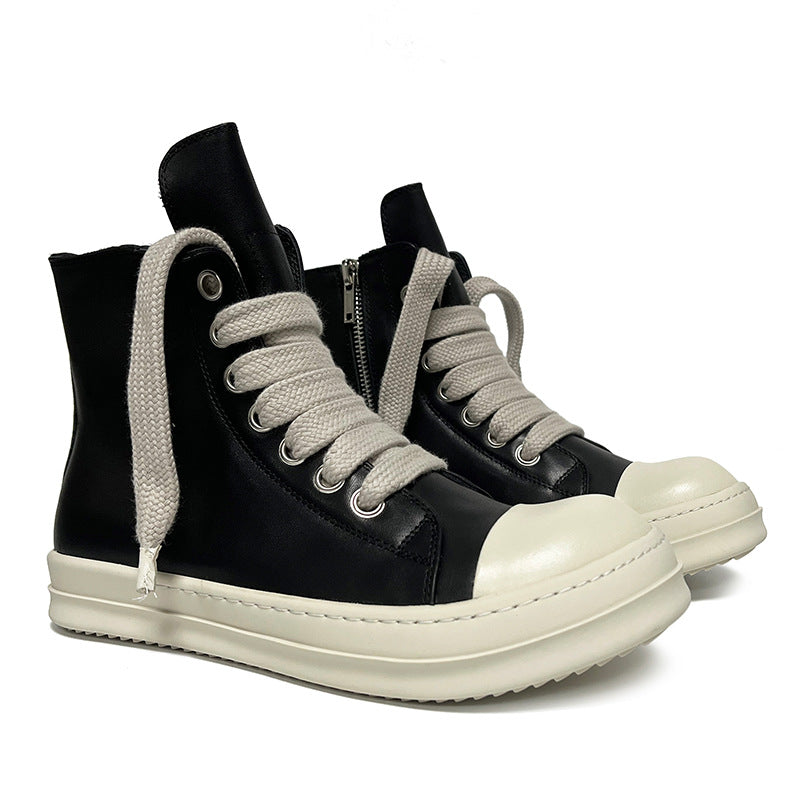 Black high-top sneakers with white soles and laces on a white background