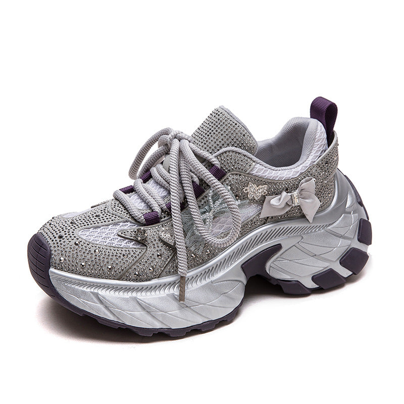 Silver glittery sneaker with purple accents on a white background