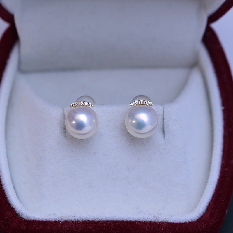 Pearl earrings with silver accents in a jewelry box