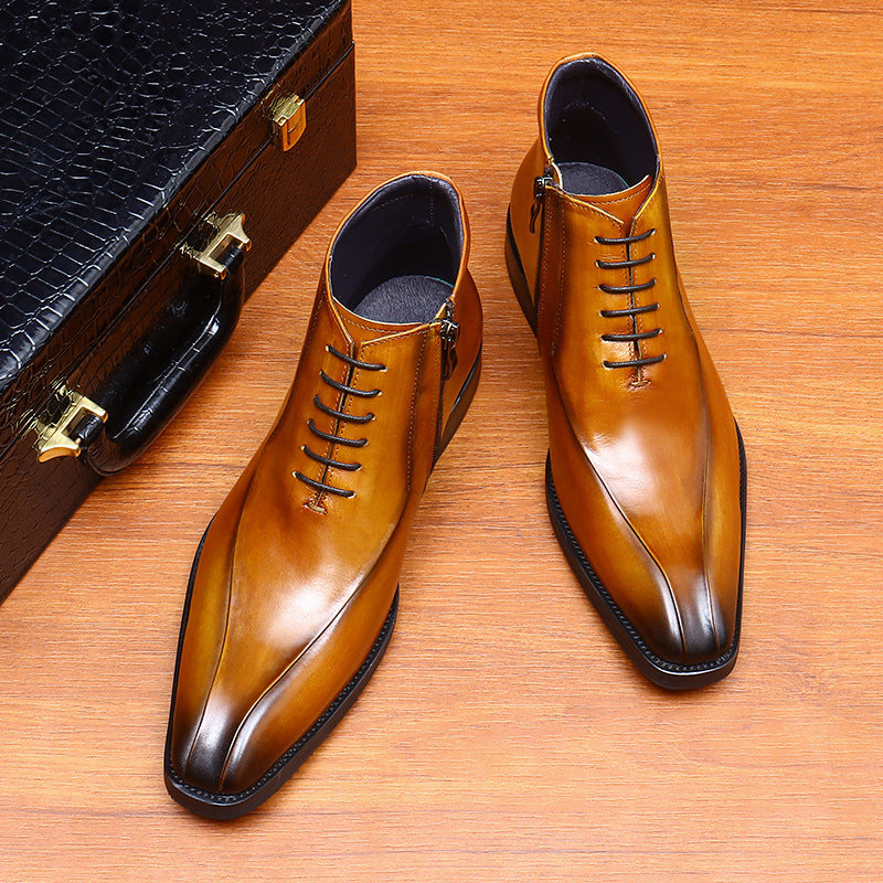 Pair of brown dress shoes on a wooden surface with a black suitcase.
