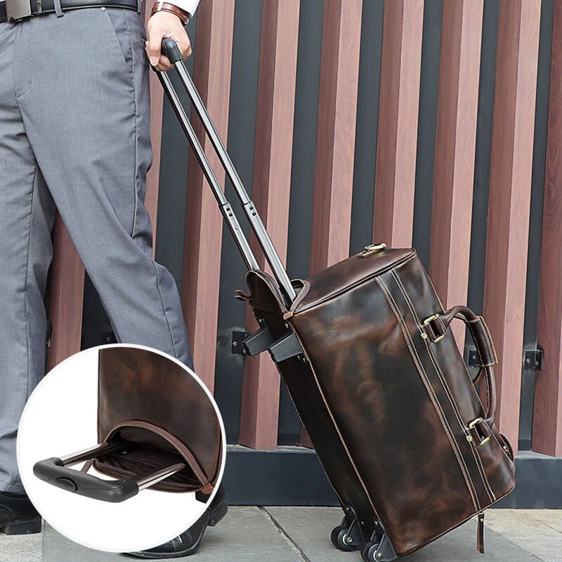 Brown leather suitcase with wheels being pulled by a person, with a close-up of the suitcase's footrest.