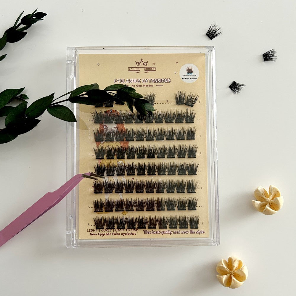 Eyelash extensions in a clear plastic case on a white background with decorative elements.
