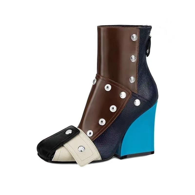 Multicolored boot with decorative studs on a white background