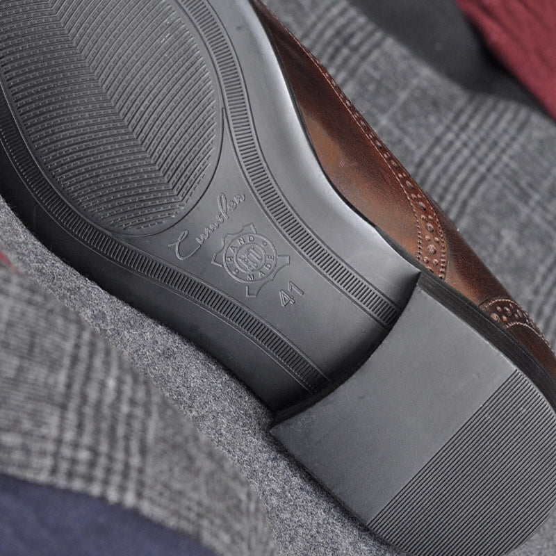 Close-up of a shoe sole with brand logo on a textured fabric background