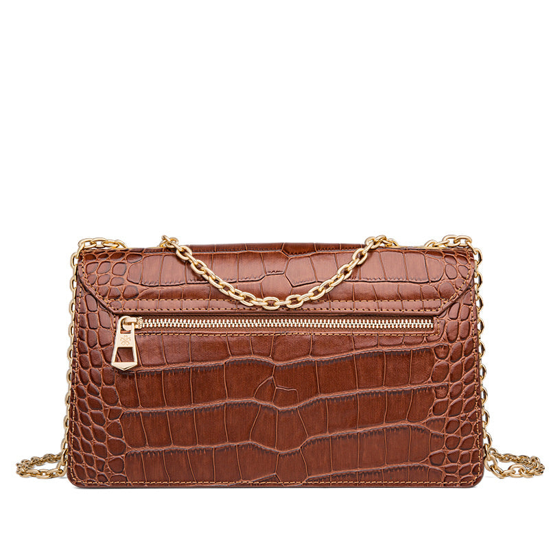 Brown crocodile-patterned handbag with a gold chain on a white background