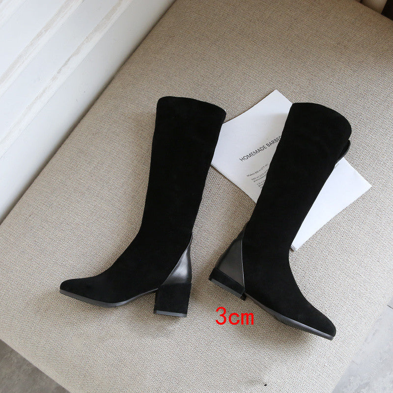Black knee-high boots with a 3cm block heel on a neutral background