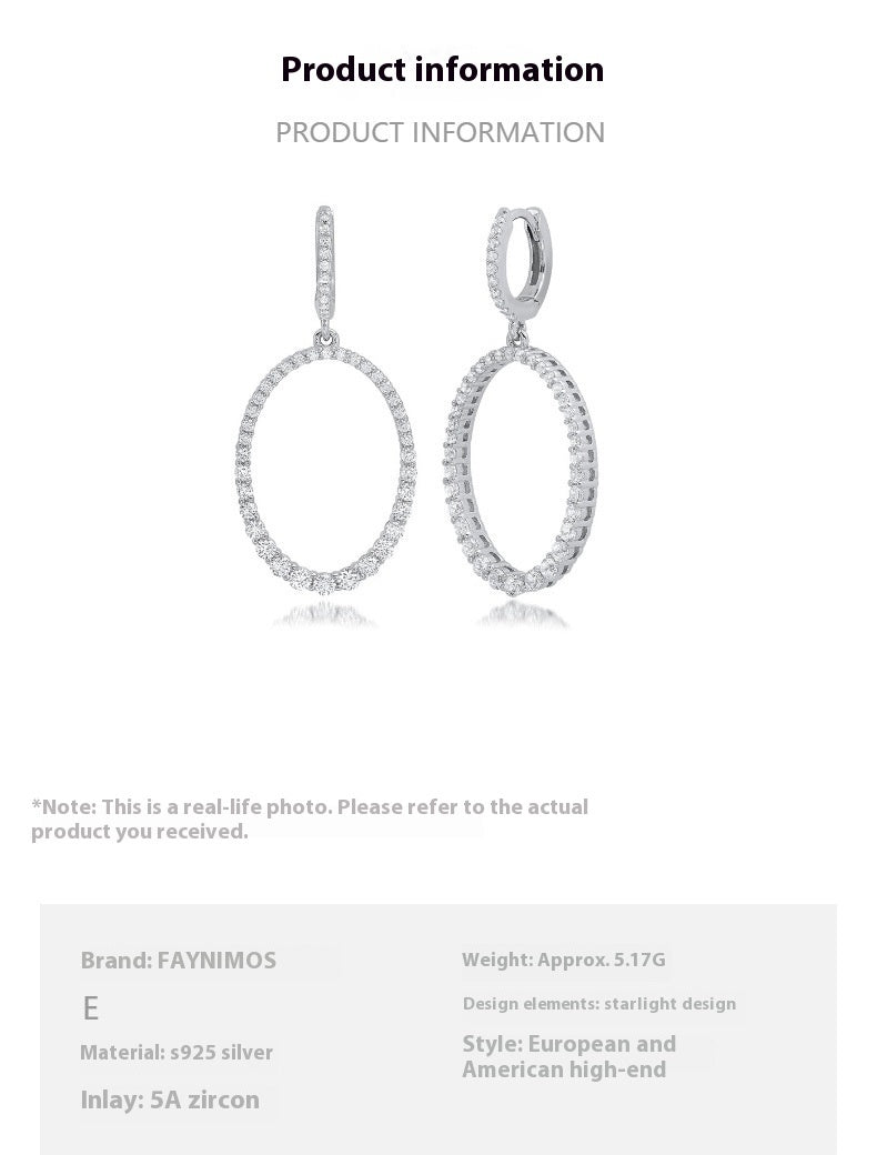 Pair of silver earrings with oval design on a white background