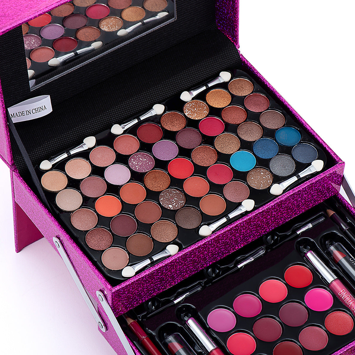 Makeup set with eyeshadows, brushes, and lipsticks in a pink case.