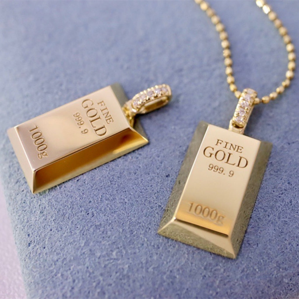 Gold bar-shaped pendants on a light blue background