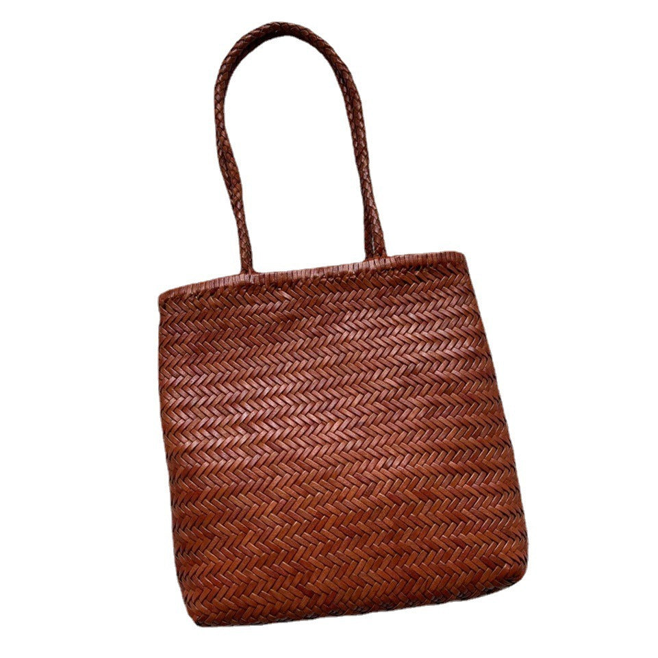 Brown woven handbag on a white background