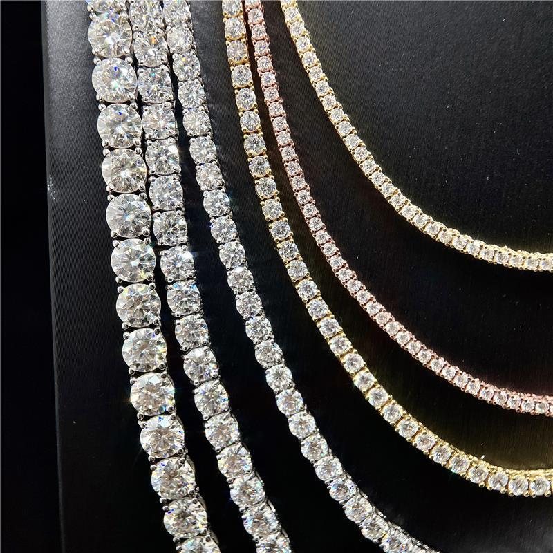 Close-up of multiple diamond necklaces on a black background