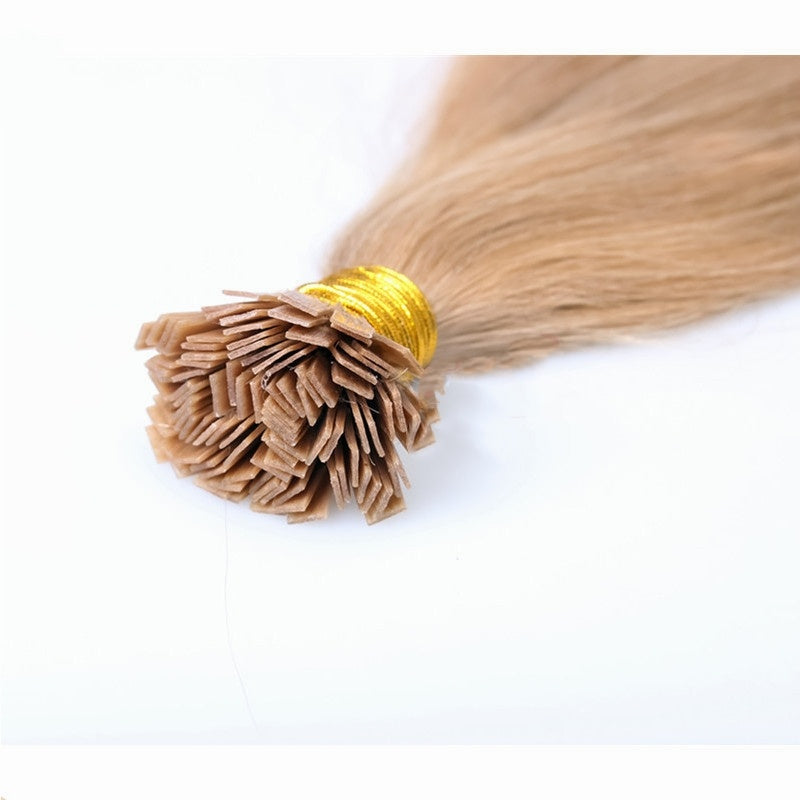 Blonde hair extensions with a gold tie on a white background