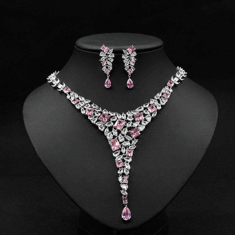 Jewelry set with necklace and earrings on a black stand