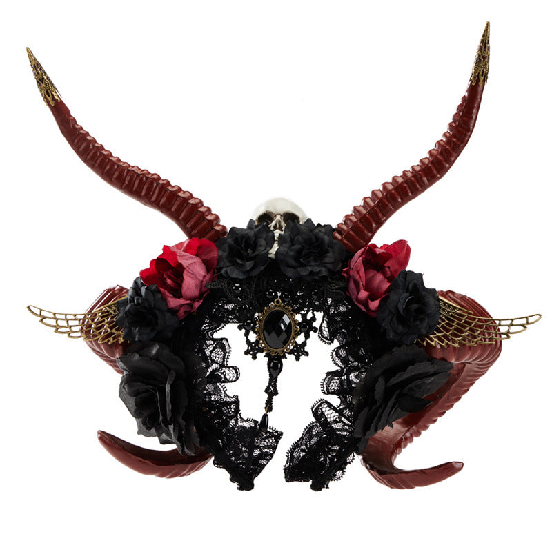 Decorative headpiece with red and black flowers, gold accents, and large horns on a white background
