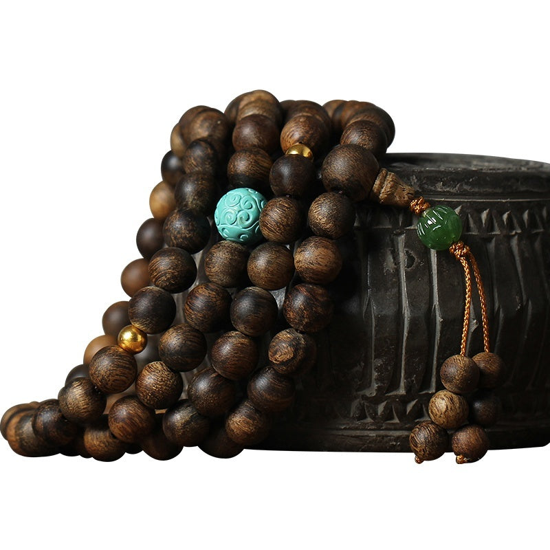 Wooden beaded bracelet with colorful beads on a white background