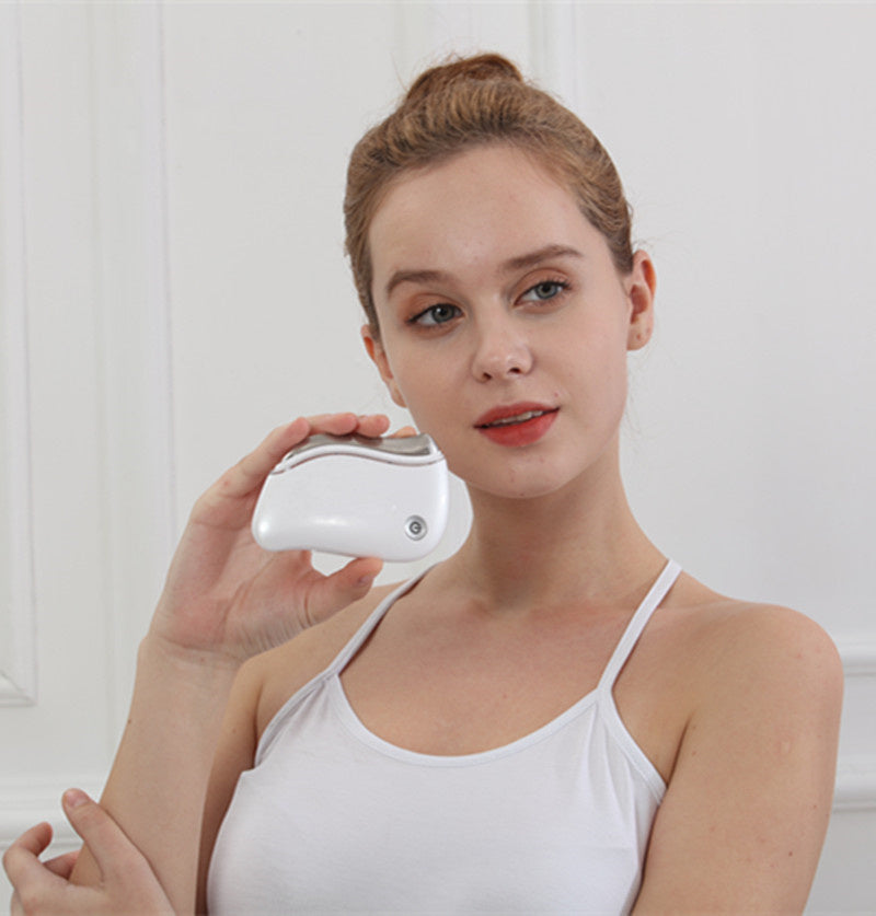Woman holding a white electronic device against a light background