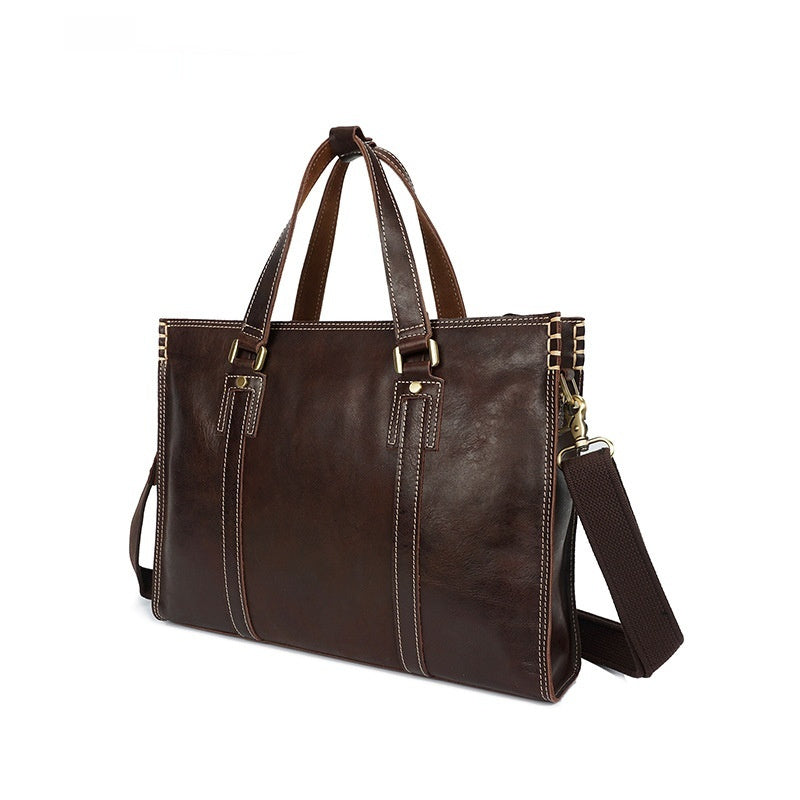Brown leather tote bag with shoulder strap on a white background